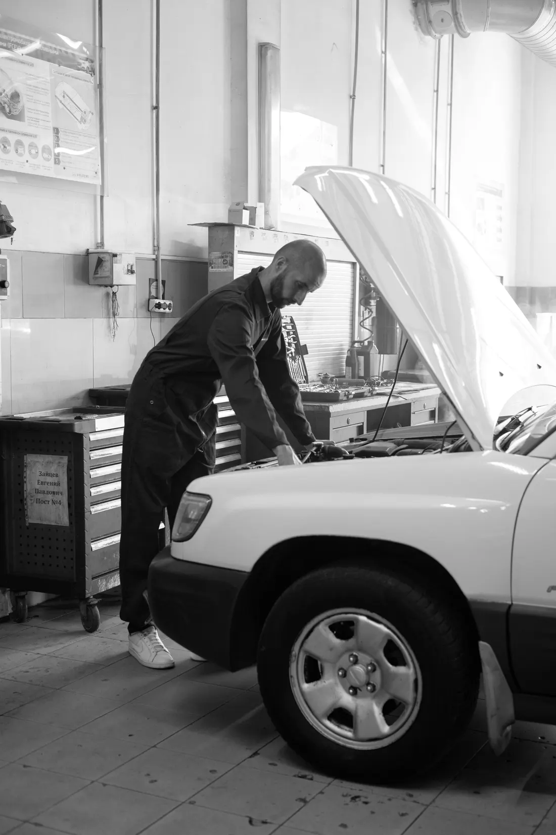 Illustrative stock photograph of a mechanic working beside an open bonnet